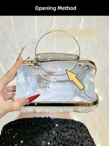 Detail of white pearl clutch showing the push-back diamond clasp and inner chain strap