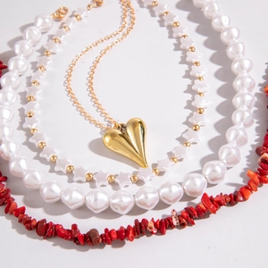 Bohemian layered necklace set with heart charm, faux pearls and colorful beads on white