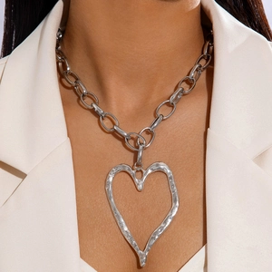 Silver tone multi-layer chunky chain necklace featuring a large hammered heart pendant