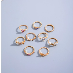 Set di 9 anelli dorati con cristalli rosa, stelle, cuori e motivo LOVE alla moda