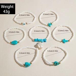 Detailed view of bohemian turquoise bead bracelets with starfish and heart charms
