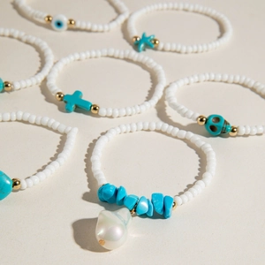 Multilayer bohemian beaded bracelet set with turquoise charms and evil eye detail