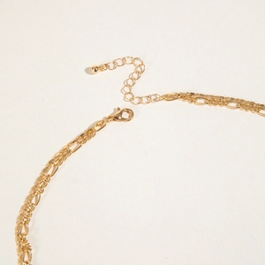 Detail of gold double-layer necklace showing lobster clasp and adjustable extender chain