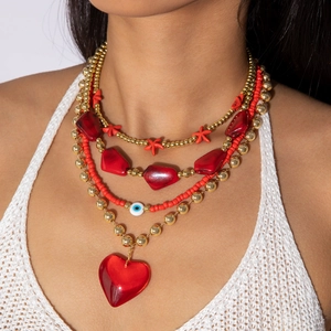 Layered acrylic red heart and gold bead necklace featuring evil eye charms for women
