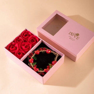 Romantic gift box featuring six red roses and a heart charm bracelet for Valentine Day