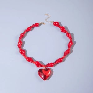 Detail shot of the red acrylic heart pendant and irregular chunky beaded necklace chain