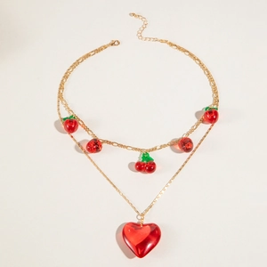 Double layered gold chain necklace featuring red acrylic heart and strawberry pendants