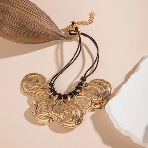 Detail of bohemian acrylic bead necklace with hammered gold alloy flower charms