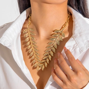 Elegant gold-colored laurel leaf necklace with textured olive branch design on a model