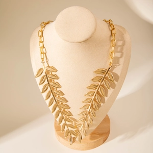 Fashion gold-toned leaf necklace with bold metal chain and elegant faux pearl texture