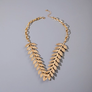 Detailed macro view of golden leaf-shaped charms and textured vein design on the necklace