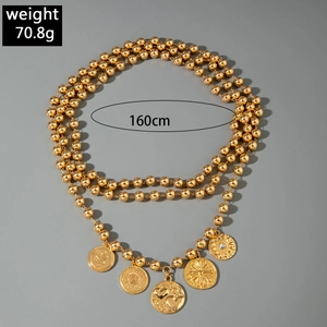 Detail view of a 160cm golden beaded necklace with engraved coin charms and 70.8g weight