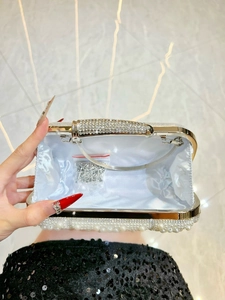 Luxury evening clutch with pearl embellishment, rhinestone handle, and satin lining