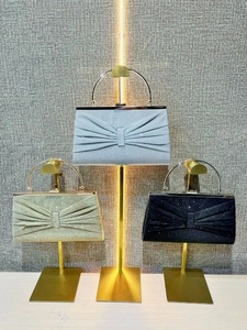 Sparkly pleated evening clutch bags with metal handles in light blue, gold, and black