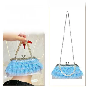 Blue lace evening bag shown as a handbag and crossbody bag with pearl handle