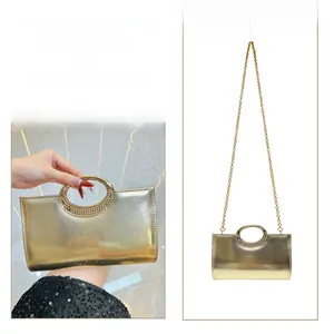 Detail of champagne gold evening clutch with circular handle and metal chain strap