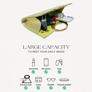 Detail showing the large capacity of champagne gold evening clutch with top metal handle