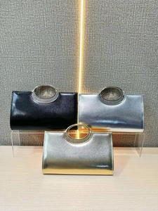 Elegant evening clutch bags in gold, silver, and black with pearl-studded ring handles