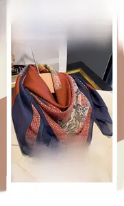 Close-up of vintage silk-cotton square scarf featuring retro floral patterns and navy border