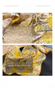 Detail shot of yellow floral scarf with sunflower prints and orange rolled edge stitching