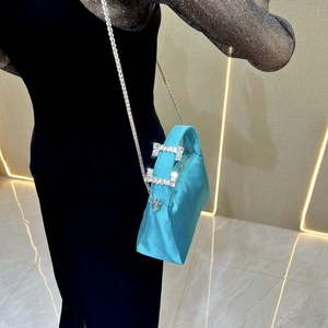 Detail of teal satin evening bag with dual rhinestone buckles and silver chain strap
