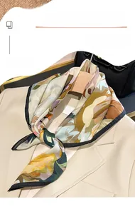 Close-up of lightweight floral scarf styled on a beige blazer with a vintage aesthetic