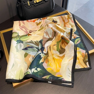 Floral silk square scarf with vintage rose print and black border on a gold frame