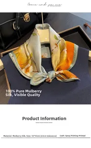 Detail of printed silk square scarf with floral pattern tied on a dark sweater