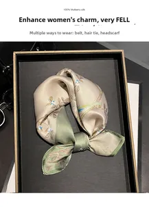 Detail of 100% mulberry silk scarf with vintage floral pattern in champagne and green