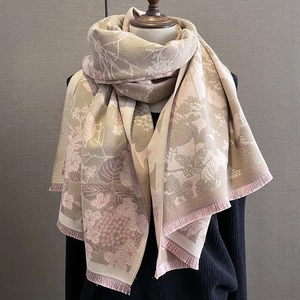 Détail de l'imprimé floral et papillon sur écharpe douce en cachemire avec franges
