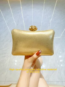 Detail of the golden glitter evening bag with flower clasp and reflective polyester finish