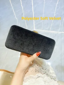Detailed close-up of premium black polyester velvet fabric on a luxury clutch bag