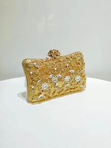 Detailed view of the gold floral evening clutch with crystals and pearl embellishments