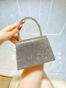 Macro shot of silver evening bag with dense rhinestones and trapezoid flap design