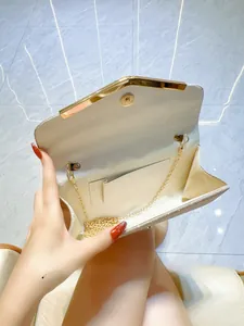 Open champagne gold sequin evening clutch bag showing spacious interior and chain