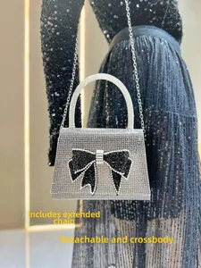 Detail showing the detachable silver metal chain strap for cross-body carry on the bag