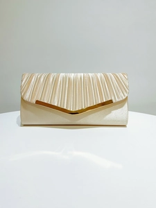 Detail of champagne satin evening clutch featuring vertical pleats and a gold V-shaped metal trim