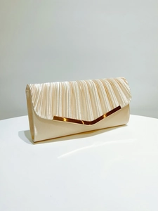 Detail of champagne satin evening clutch featuring elegant vertical pleats and golden V-trim