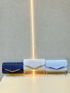 Elegant pleated evening clutches in navy, silver, and light blue with V-shaped metal trim