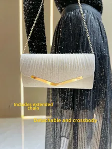 Silver glitter evening clutch with gold V-trim shown worn as a crossbody with chain