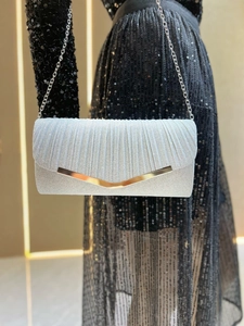 Detail of pleated silver glitter clutch bag with metal V-trim and delicate chain strap