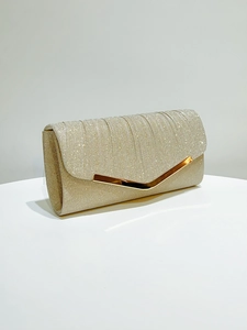Detail of champagne gold glitter evening clutch bag with V-shaped metal trim decoration