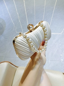 Elegant ivory pleated satin clutch bag featuring pearl handle and diamond-encrusted buckle