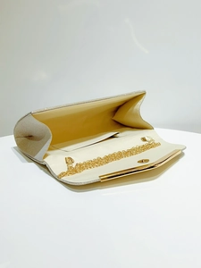 Detailed interior of glitter evening clutch with golden chain strap and inner pocket