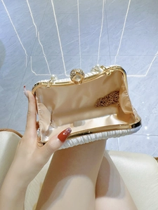 Pleated white satin evening clutch with pearl clasp and gold chain strap interior view