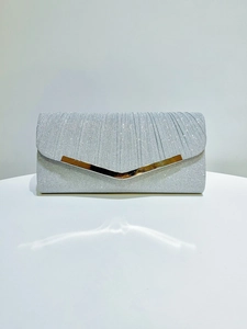 Macro shot of silver glitter pleated evening bag featuring a gold V-shaped metal trim