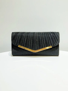 Macro view of black pleated evening clutch with glitter fabric and V-shaped gold metal trim