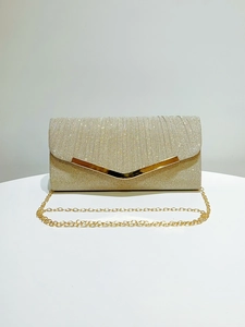 Detailed close-up of gold sequin evening clutch featuring a V-shaped metal trim and chain