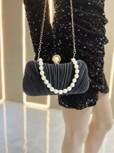 Black pleated satin evening bag with pearl handle and delicate gold chain strap detail