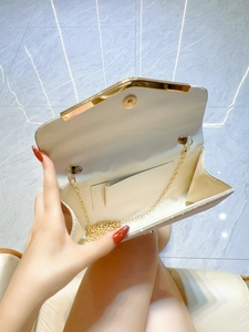 Elegant pleated evening clutch bag with champagne glitter finish and gold chain strap